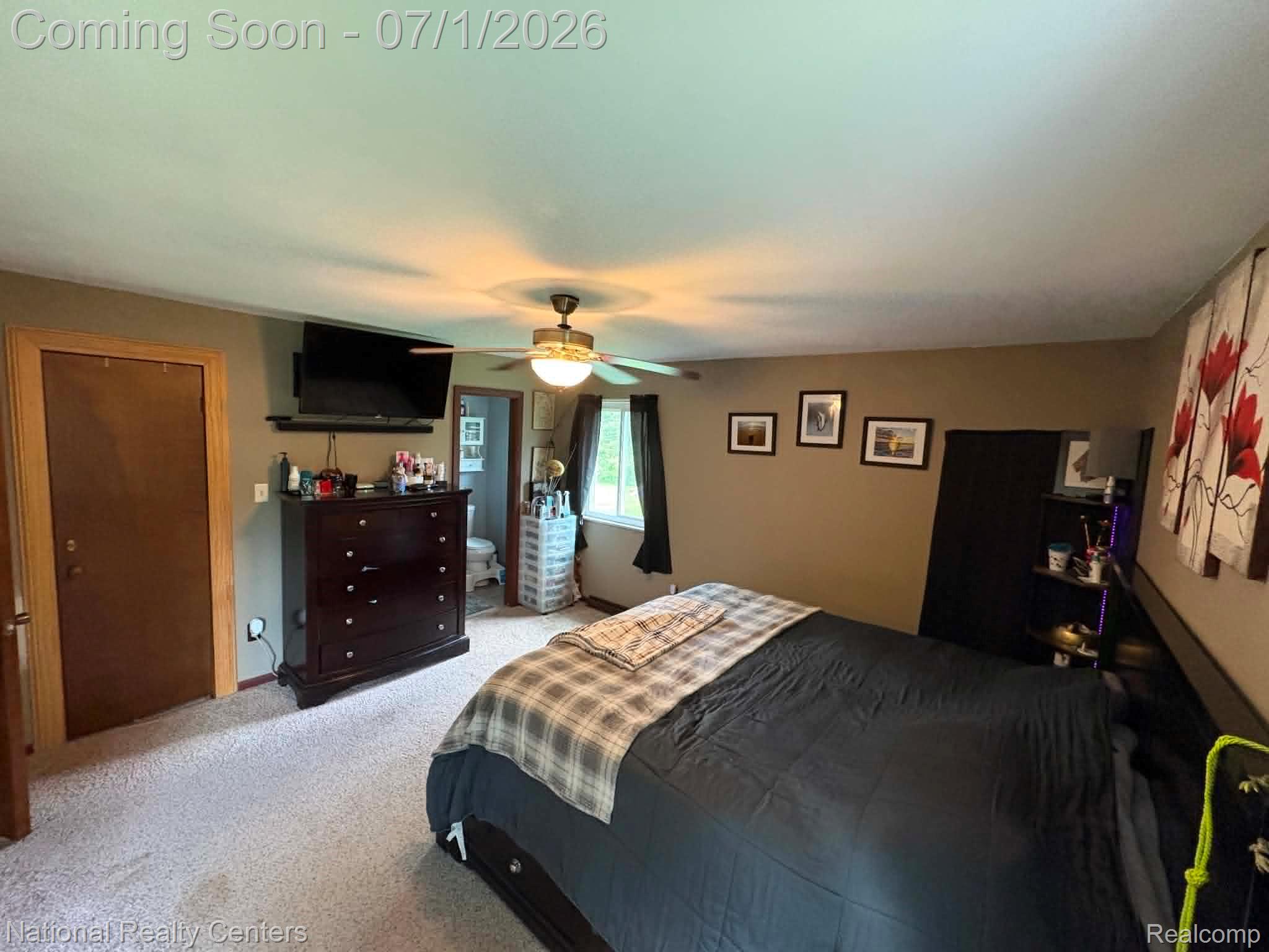 1330 Brauer Road Oxford, MI 48371 - Photo 41 of 54 Carpeted bedroom with a ceiling fan light fixture, a window with dark curtains, and a door leading to a bathroom