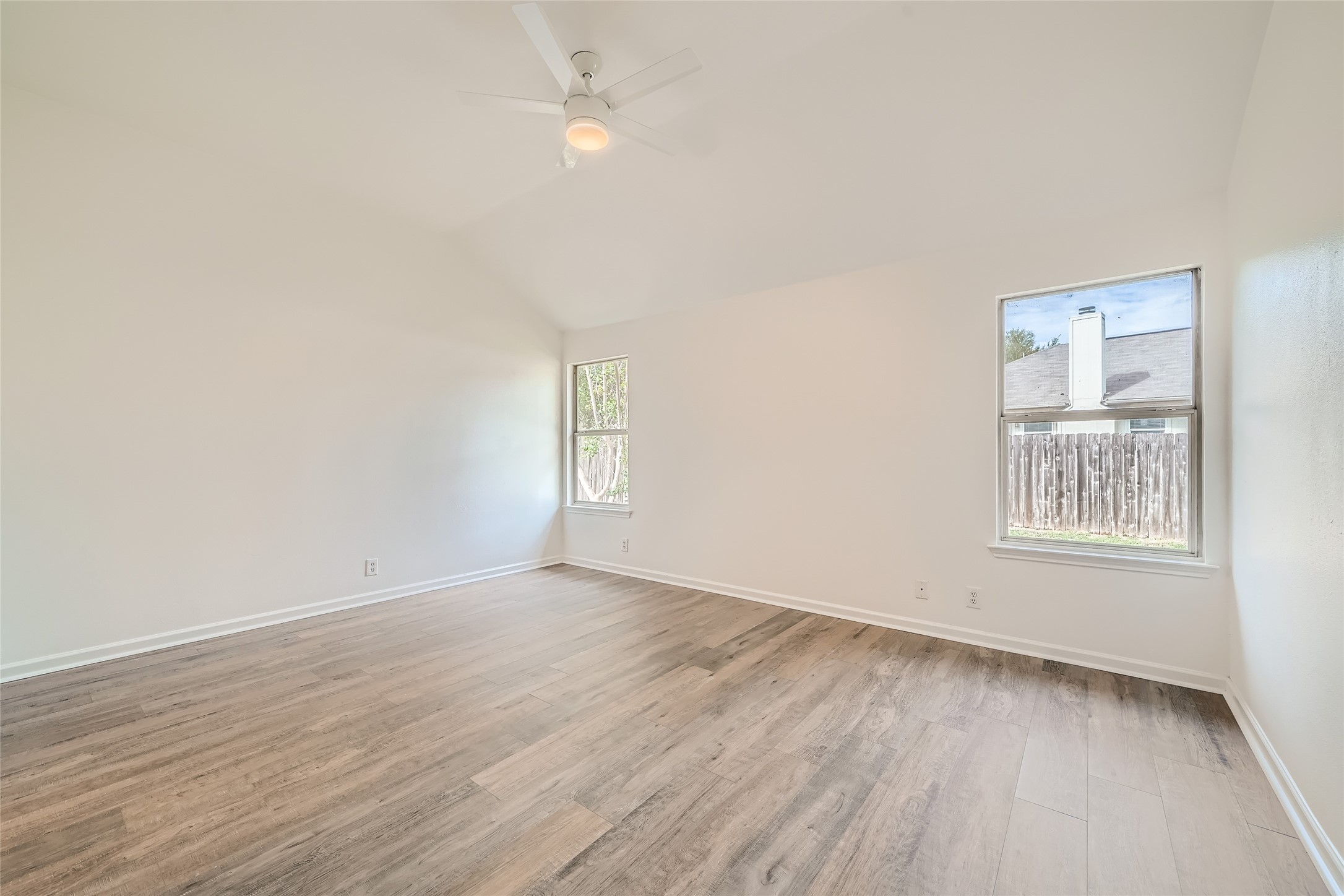 905 Jasmine Trail Georgetown, TX 78626 - Photo 14 of 31 an empty room with wooden floor and windows