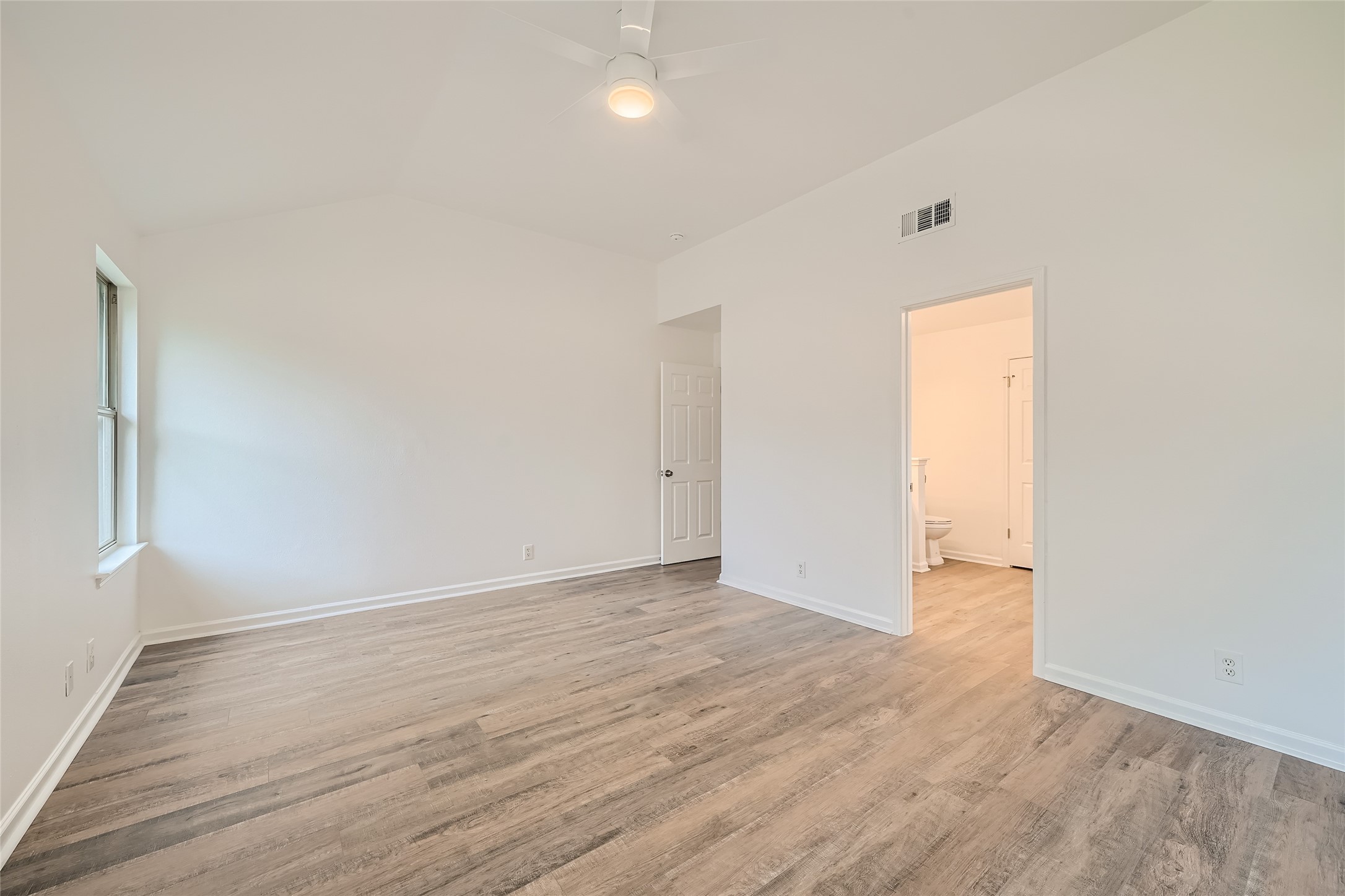 905 Jasmine Trail Georgetown, TX 78626 - Photo 15 of 31 an empty room with wooden floor and windows