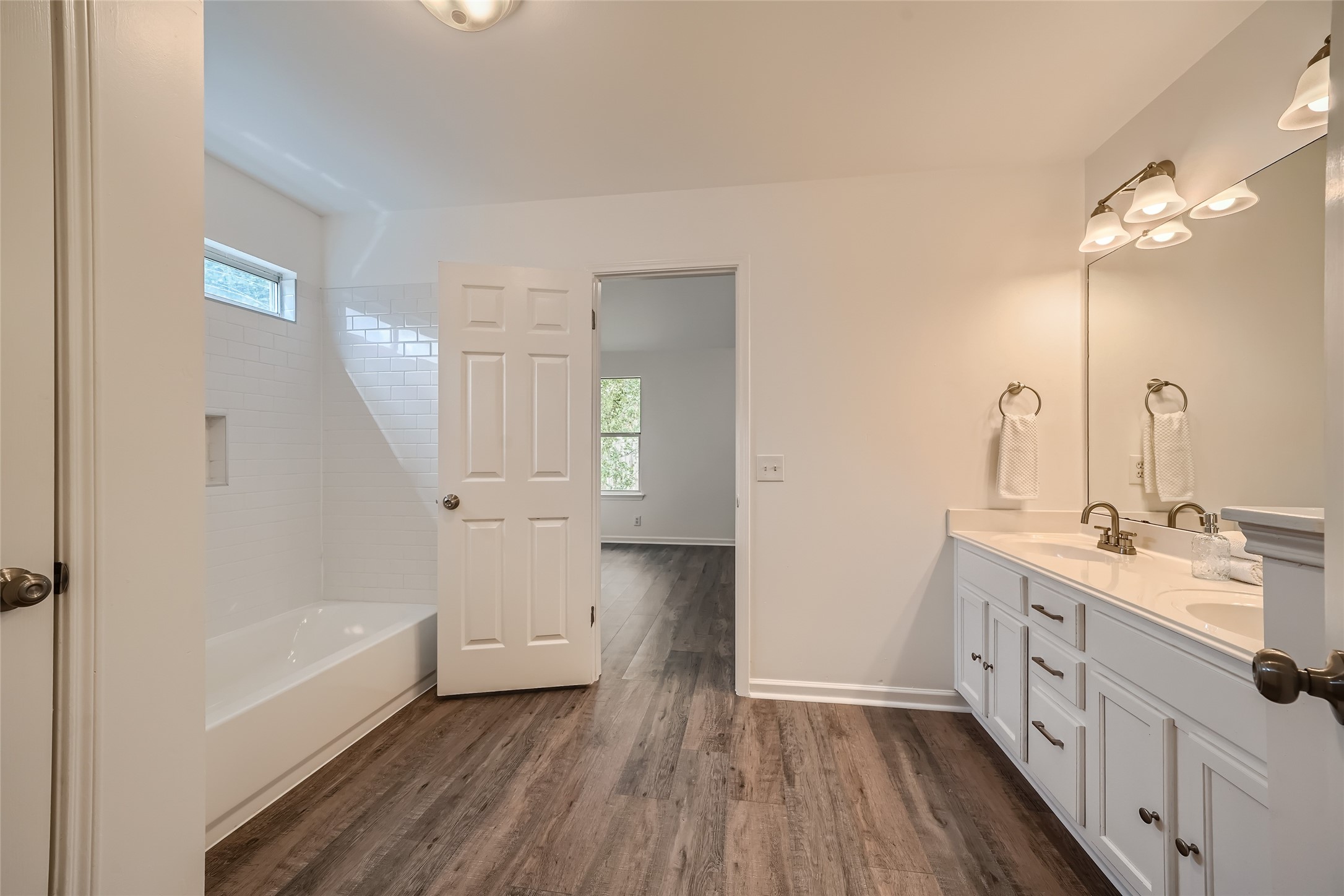 905 Jasmine Trail Georgetown, TX 78626 - Photo 18 of 31 a bathroom with a double vanity sink a mirror and a bathtub
