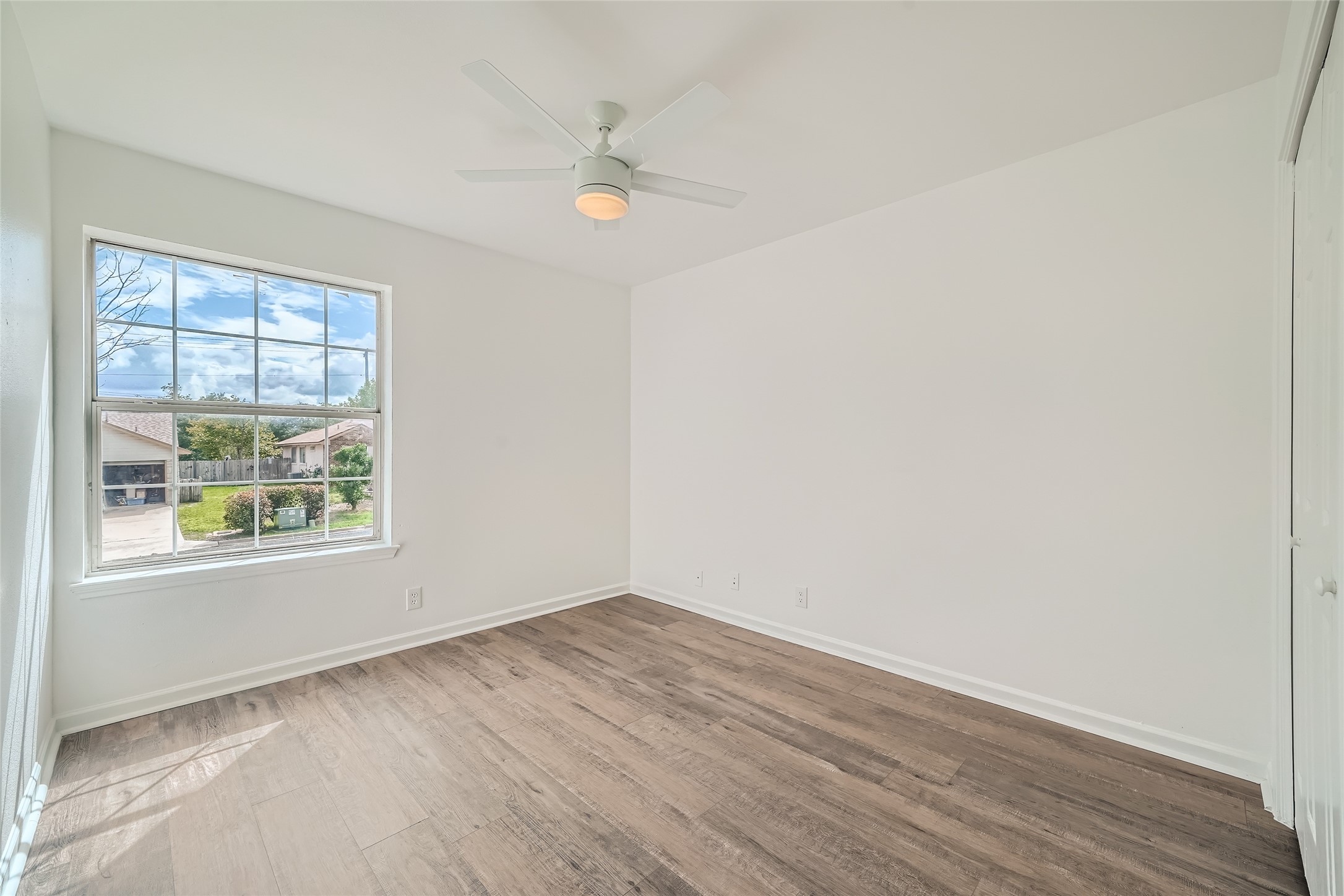 905 Jasmine Trail Georgetown, TX 78626 - Photo 20 of 31 an empty room with wooden floor and windows