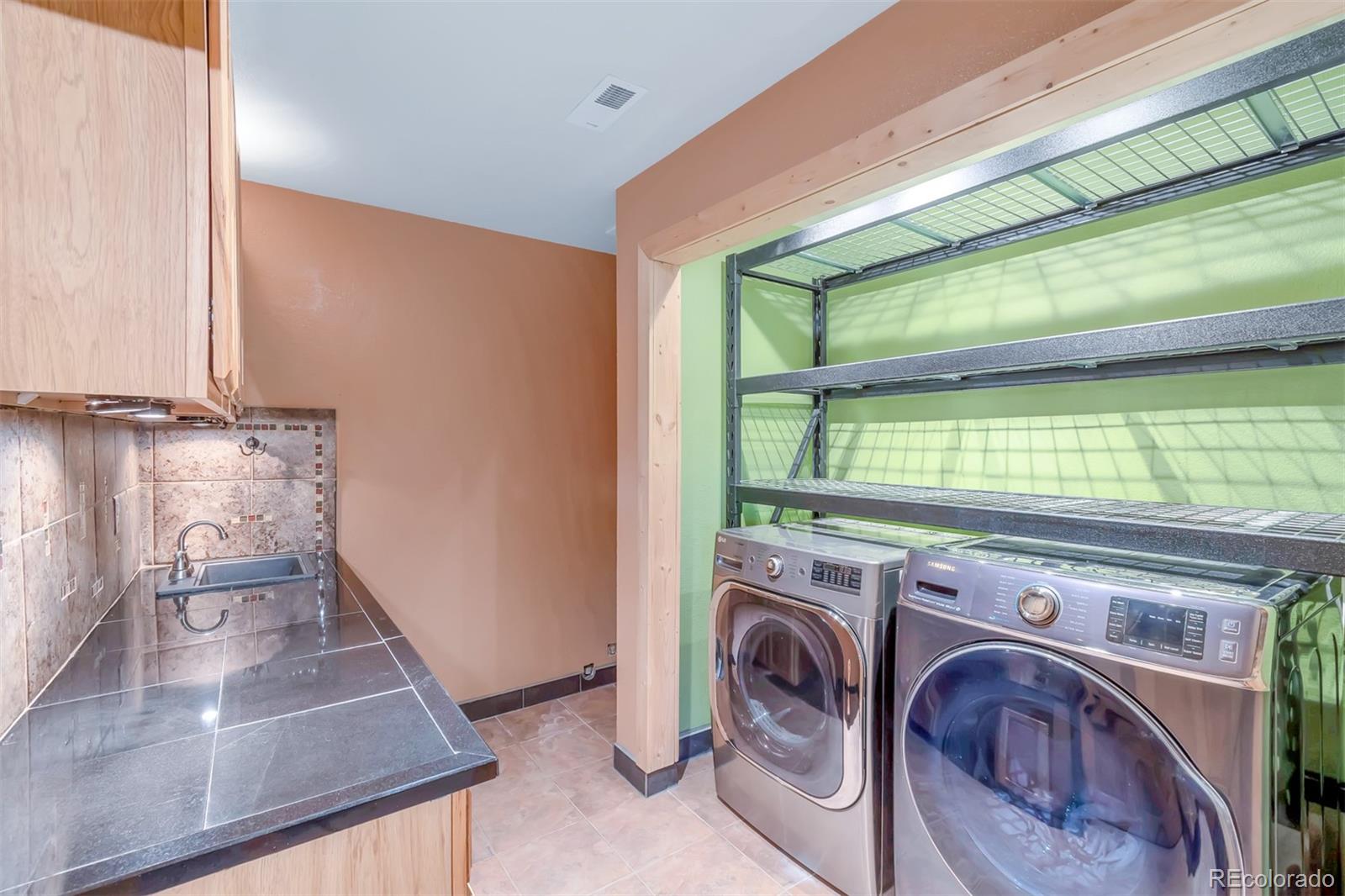 195 Bulldogger Road Bailey, CO 80421 - Photo 28 of 38 a view of a storage & utility room with washer and dryer