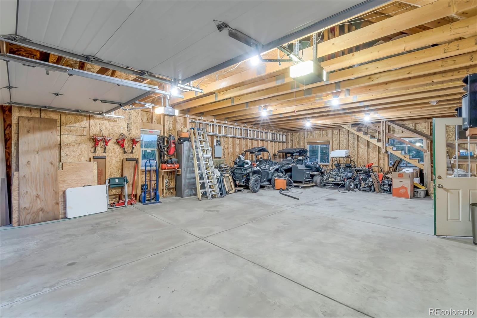 195 Bulldogger Road Bailey, CO 80421 - Photo 29 of 38 a view of a garage with storage