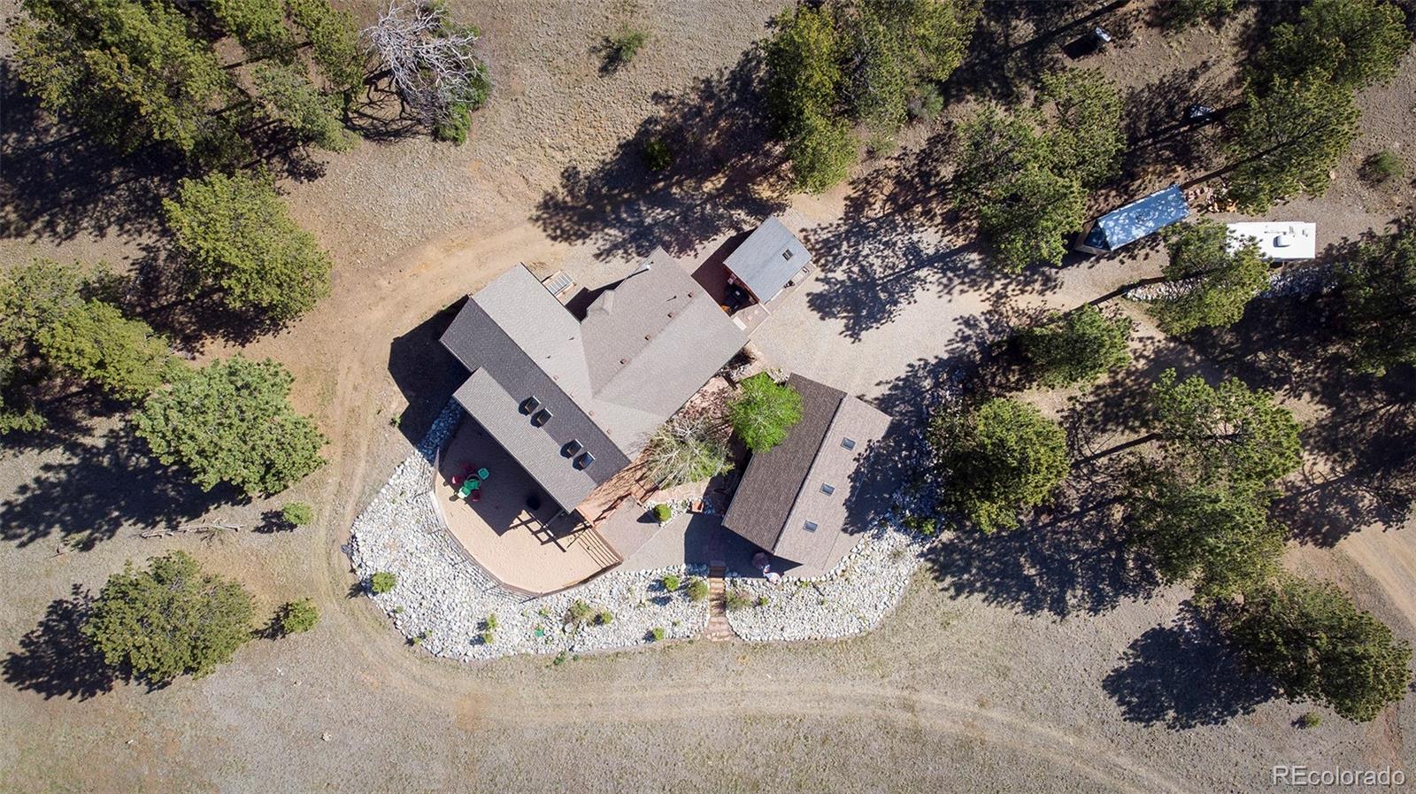 195 Bulldogger Road Bailey, CO 80421 - Photo 3 of 38 an aerial view of a fireplace with large trees