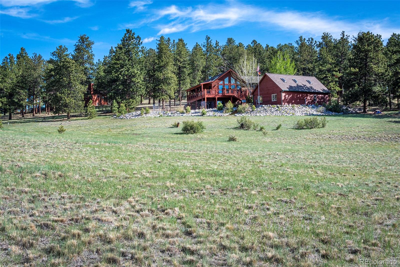 195 Bulldogger Road Bailey, CO 80421 - Photo 38 of 38 a view of a big house with a big yard and large trees