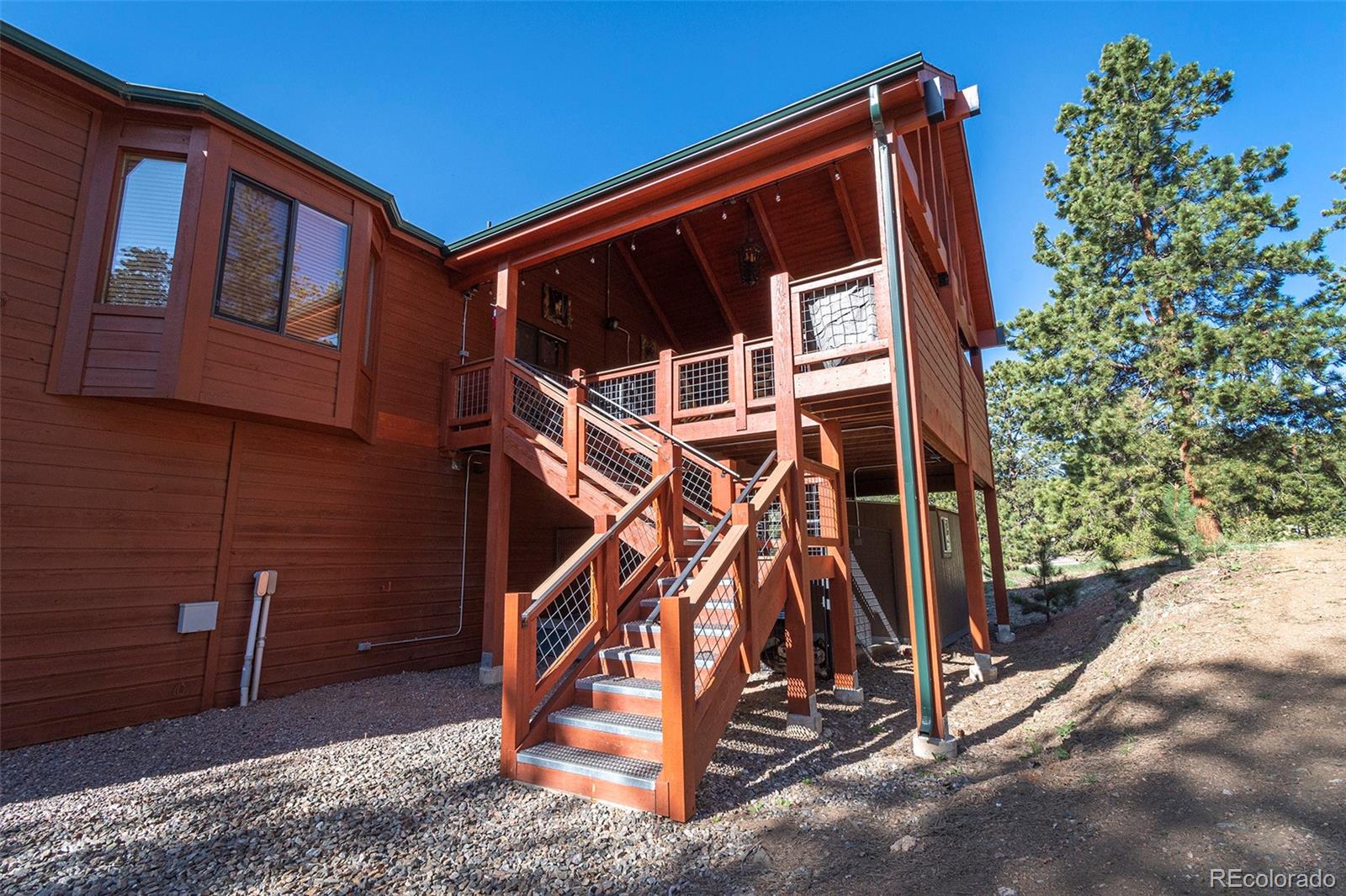 195 Bulldogger Road Bailey, CO 80421 - Photo 7 of 38 a view of an house with backyard and deck
