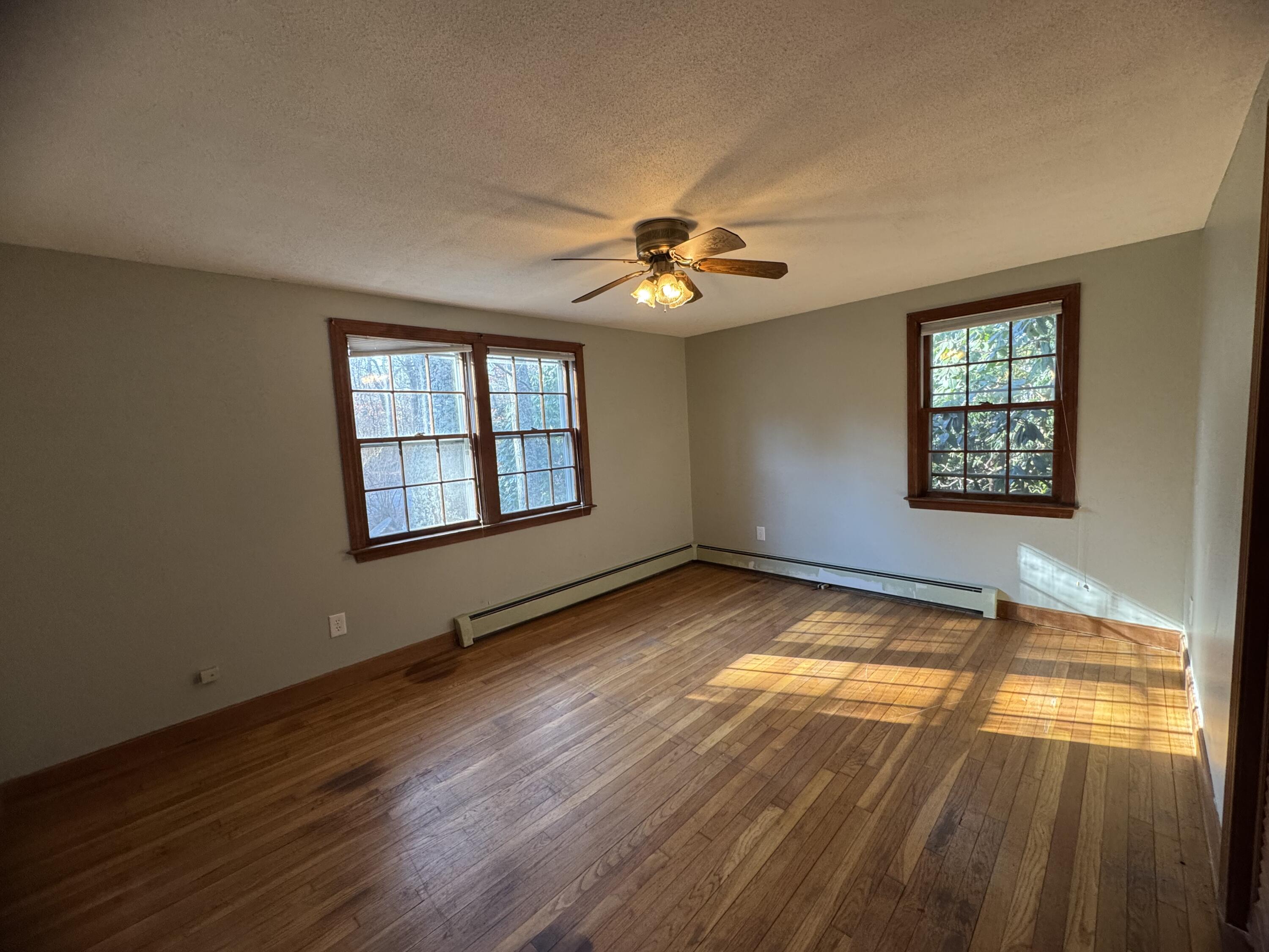 198 Great Marsh Road Centerville, MA 02632 - Photo 12 of 19 a view of an empty room with window and wooden floor