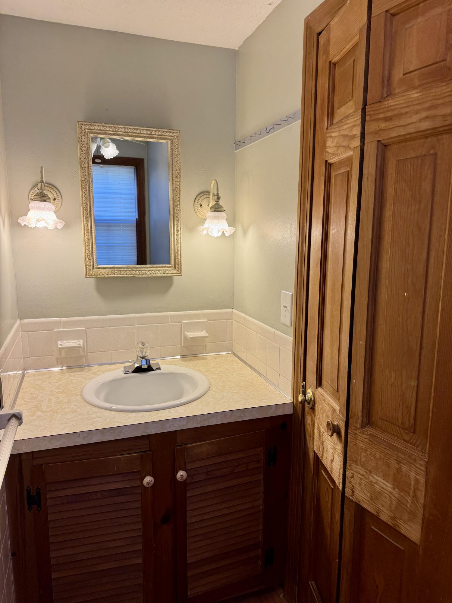 198 Great Marsh Road Centerville, MA 02632 - Photo 16 of 19 a bathroom with a sink and a mirror