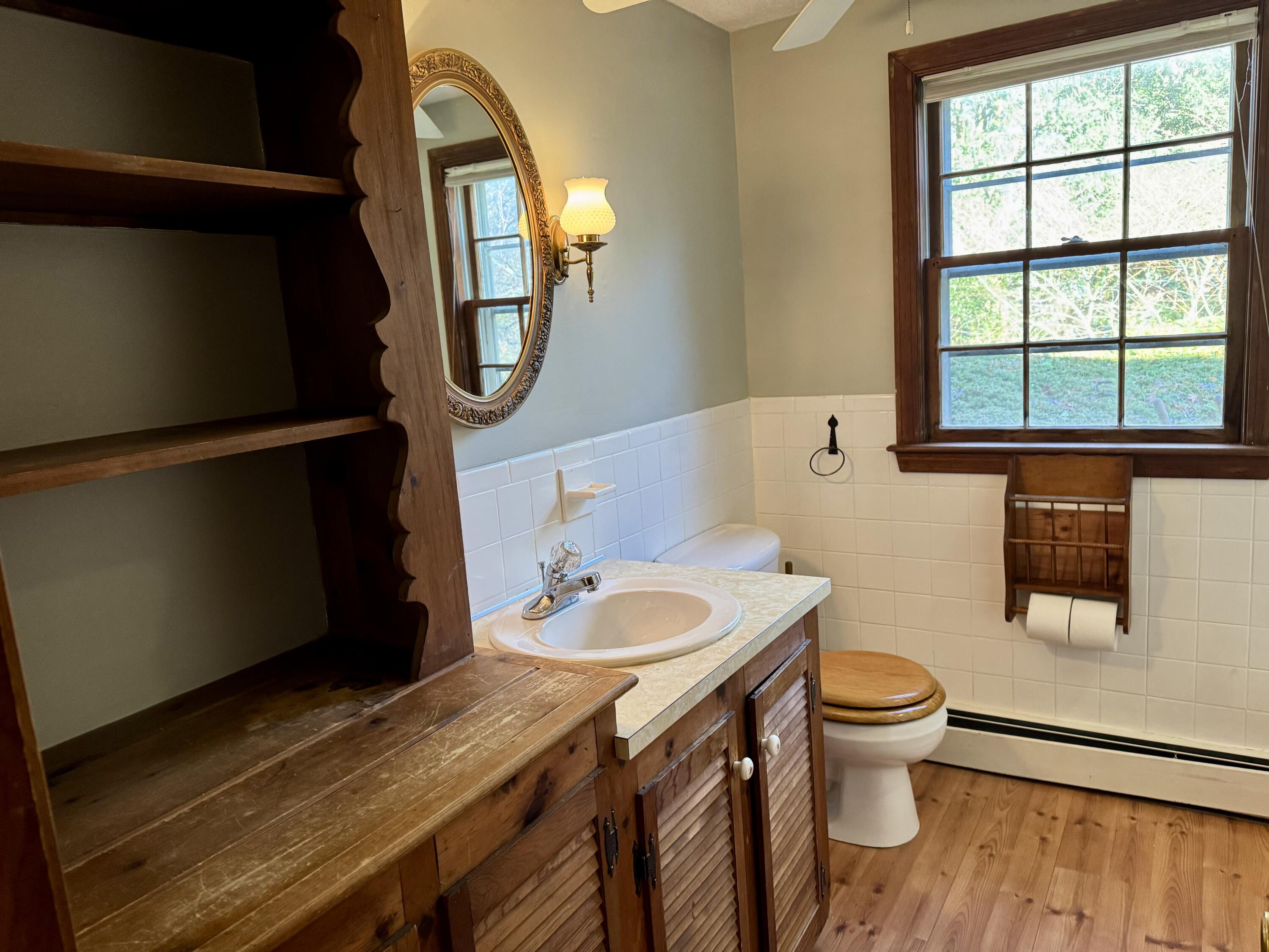 198 Great Marsh Road Centerville, MA 02632 - Photo 10 of 19 a bathroom with a granite countertop toilet sink and mirror