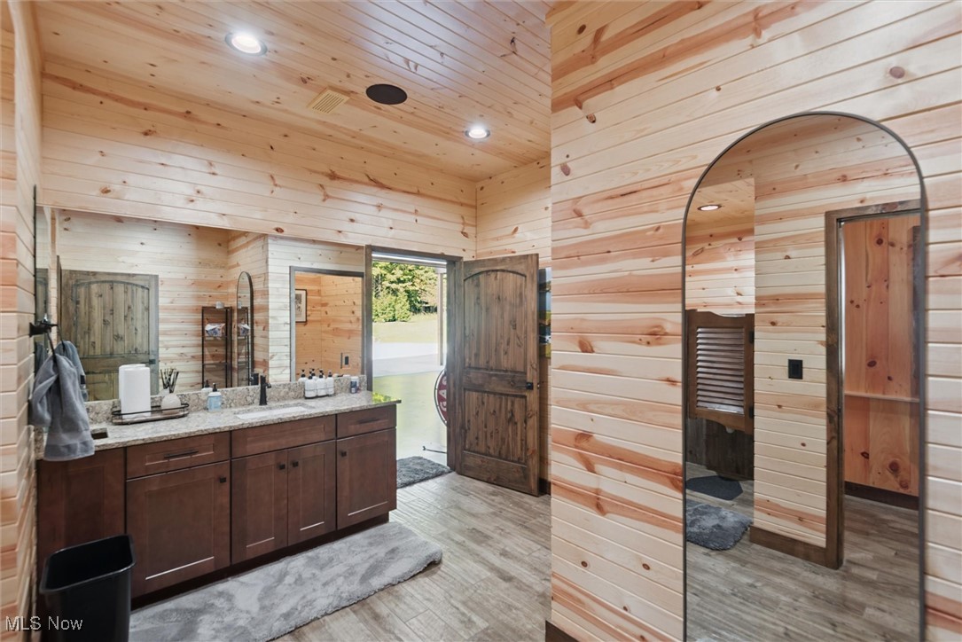290 Townline Road Aurora, OH 44202 - Photo 34 of 50 Bathroom featuring wood walls, light wood-style flooring, vanity, recessed lighting, and a relaxing sauna