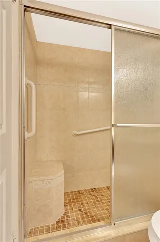 a bathroom with a glass shower door