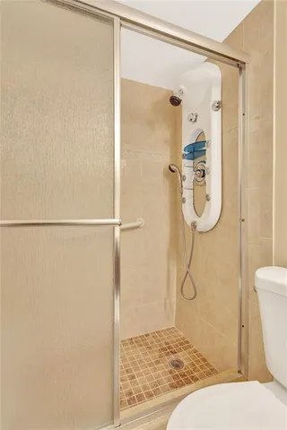 a bathroom with a shower and toilet