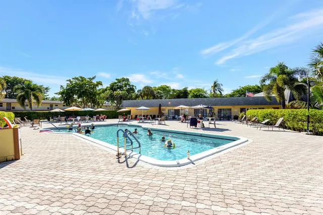 a view of a swimming pool with an outdoor seating and a garden