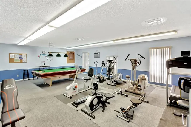 a living room with furniture gym equipment and a view of living room