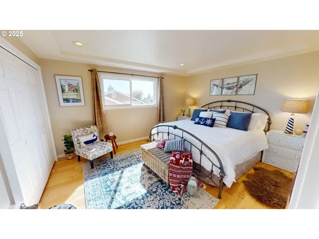 a bedroom with a bed and wooden floor