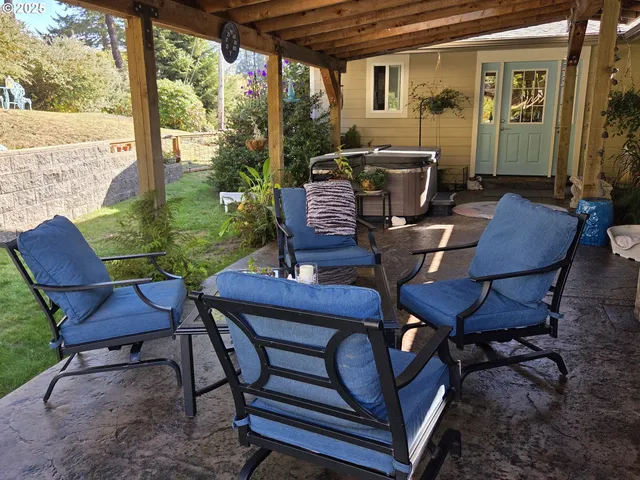 a view of a patio with table and chairs and floor to ceiling window