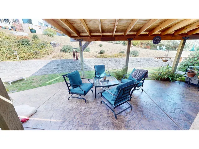 a outdoor sitting area with furniture and garden view