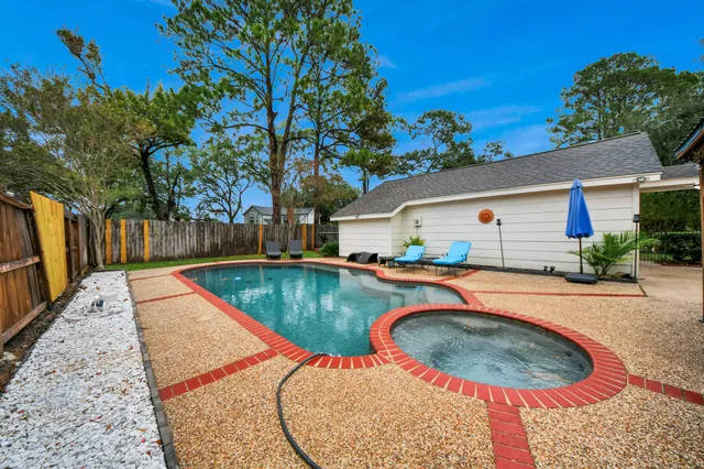 a view of a swimming pool with a patio