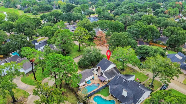 an aerial view of residential house with outdoor space and swimming pool