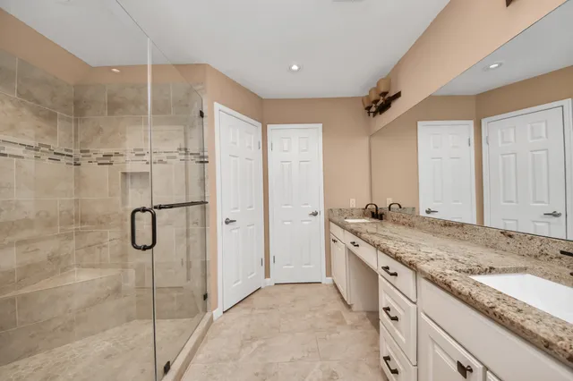 a bathroom with a glass shower door