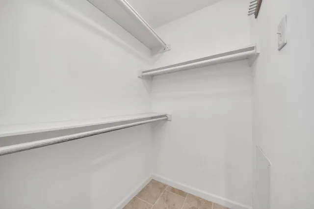 a bathroom with a granite countertop sink double and mirror