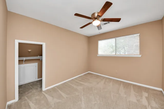 a view of room with window and ceiling fan