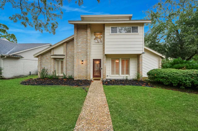 a front view of a house with a garden