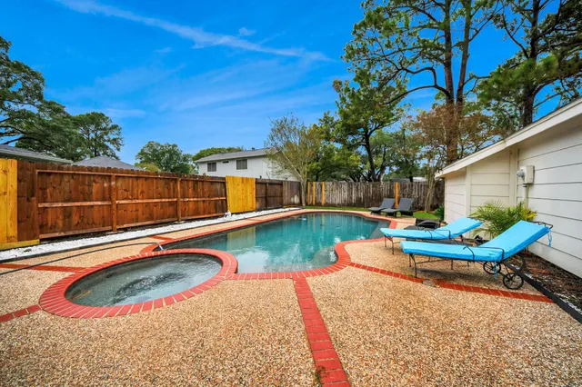 a view of a swimming pool with lounge chair