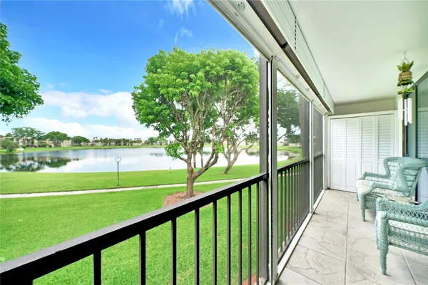 a view of balcony with furniture and garden