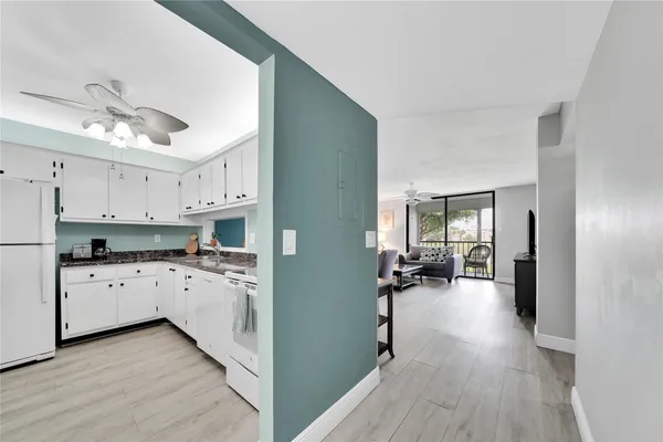 a kitchen with cabinets a sink and appliances