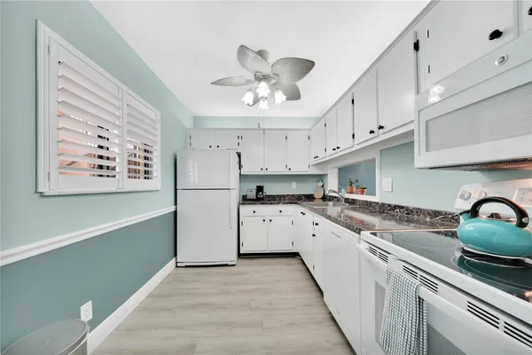 a kitchen with cabinets a sink and appliances
