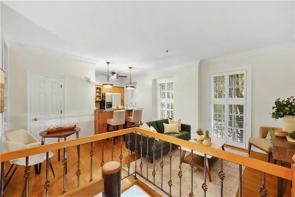 a living room with furniture windows and wooden floor