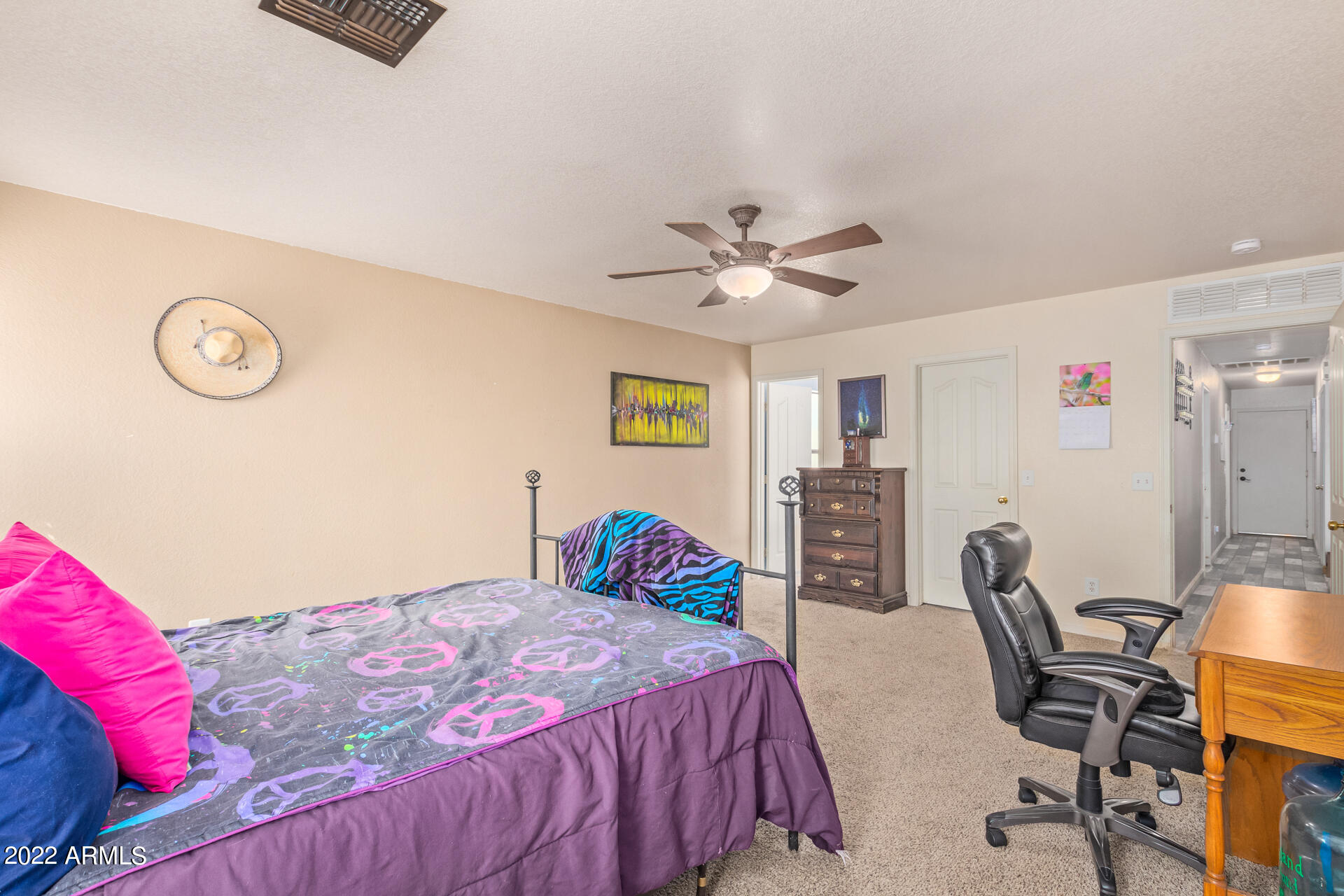 3466 South Chaparral Road Apache Junction, AZ 85119 - Photo 14 of 29 a bedroom with a bed and a chandelier