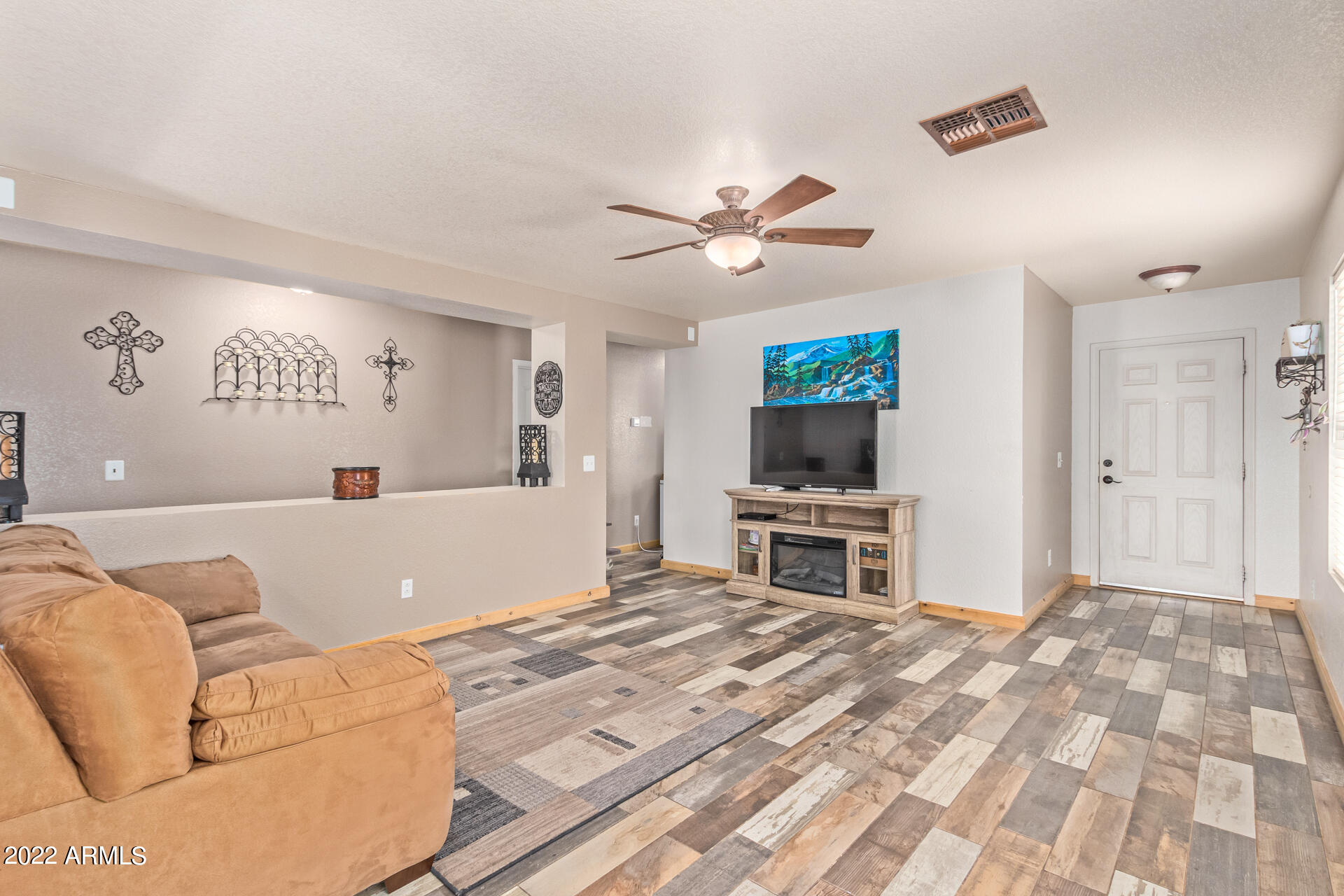 3466 South Chaparral Road Apache Junction, AZ 85119 - Photo 5 of 29 a living room with a couch and a flat screen tv