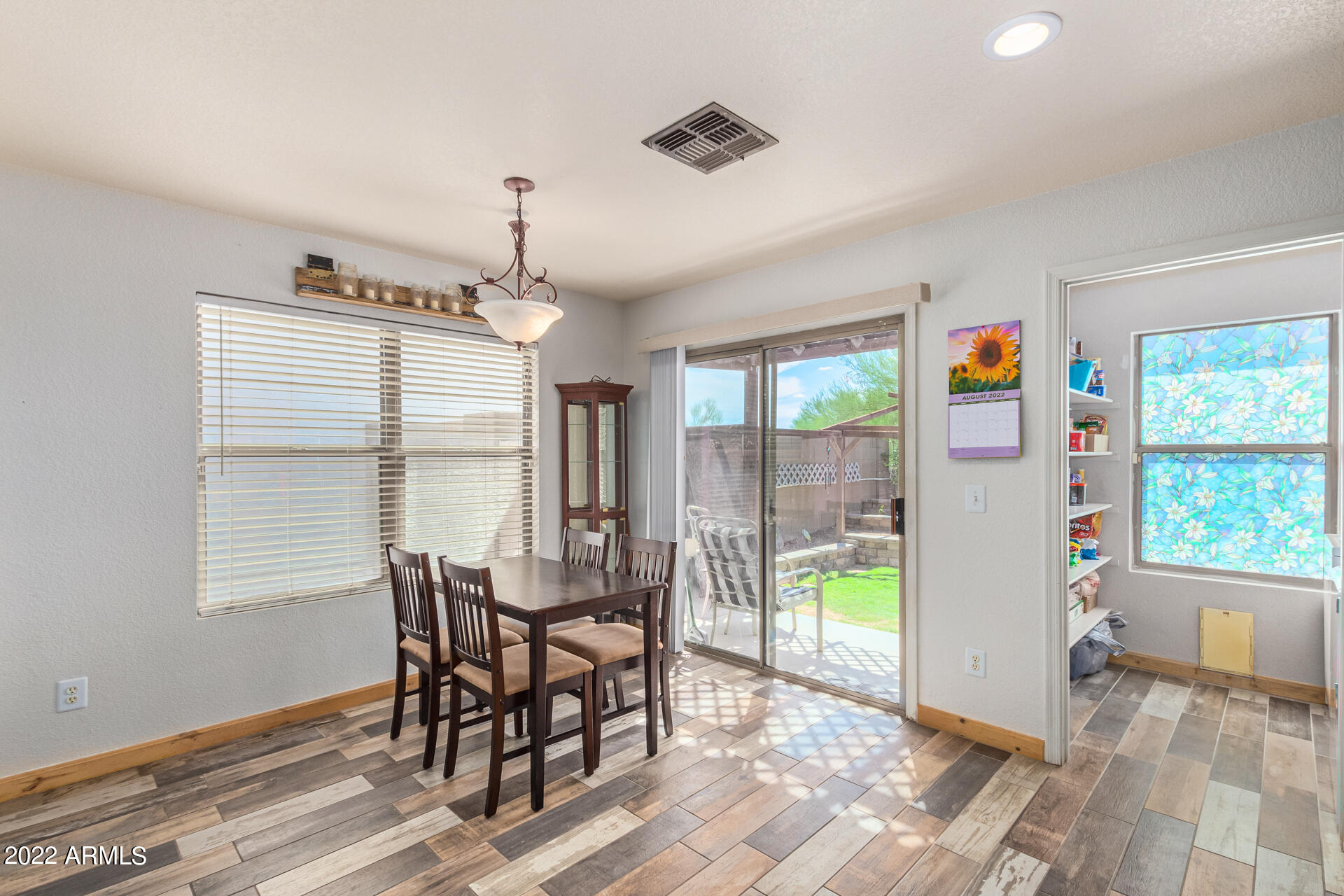 3466 South Chaparral Road Apache Junction, AZ 85119 - Photo 10 of 29 a view of a dining room with furniture a chandelier and wooden floor