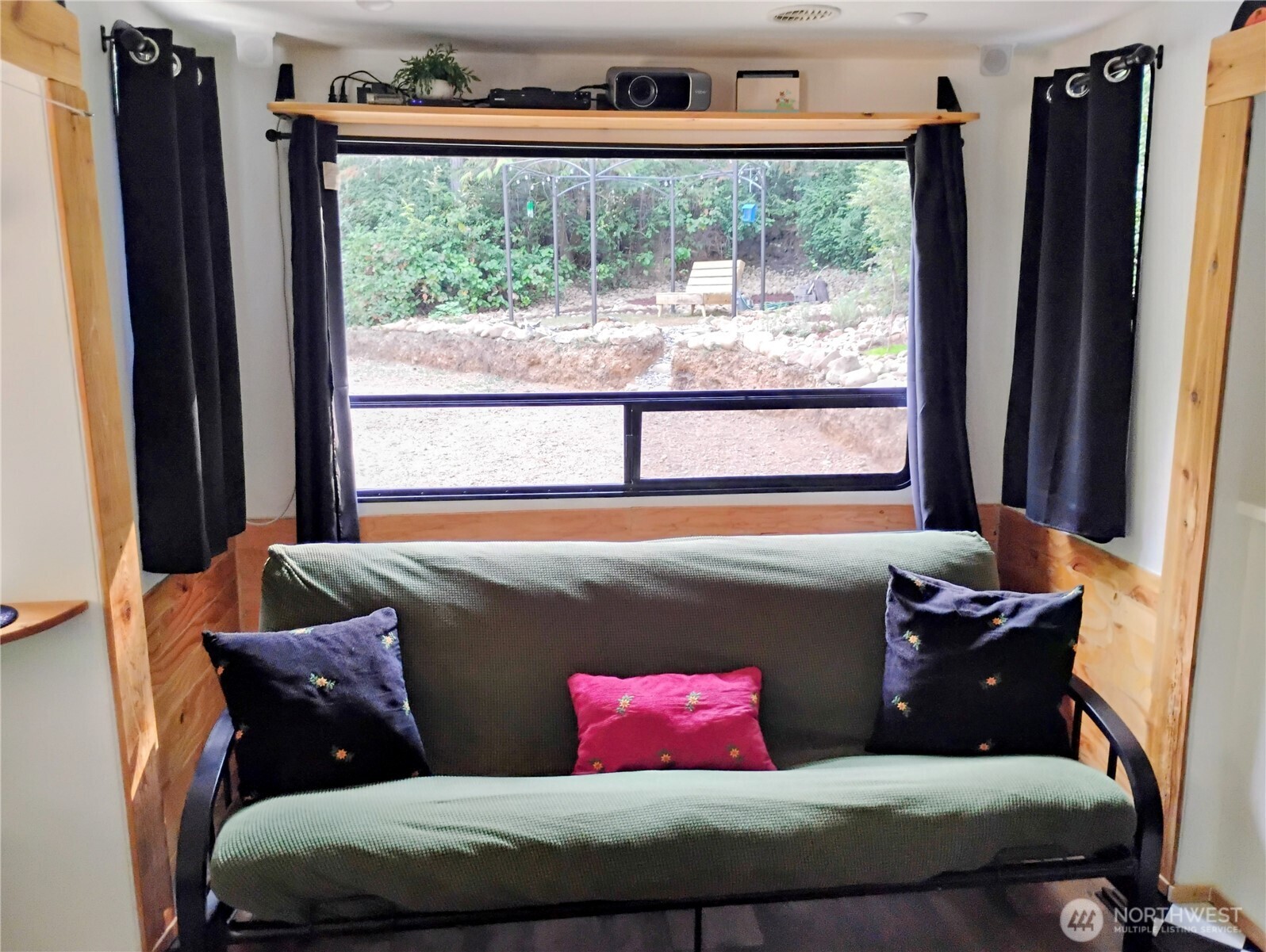 680 North Triton Heights Road Lilliwaup, WA 98555 - Photo 15 of 39 a living room with a couch and a large window