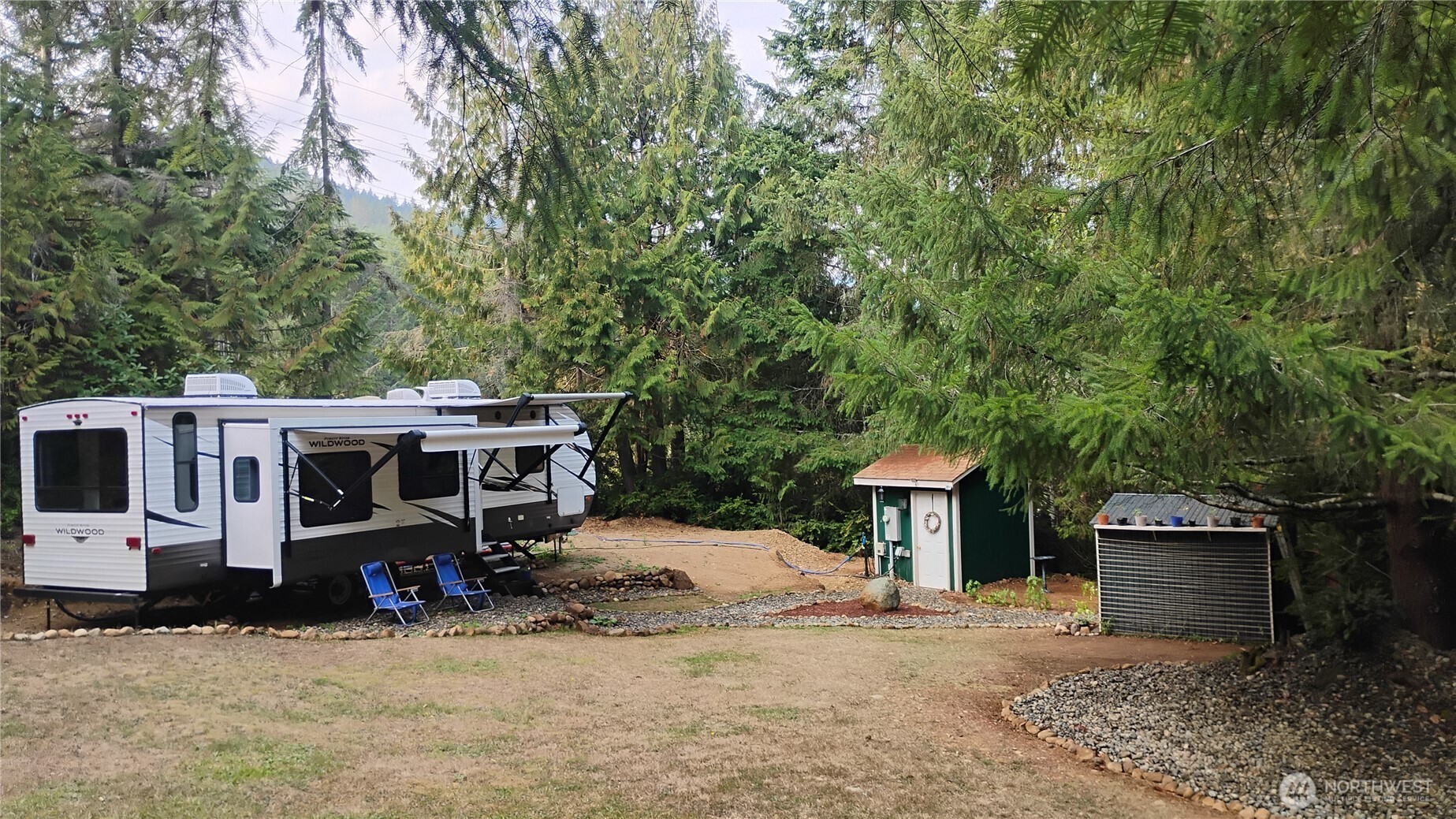 680 North Triton Heights Road Lilliwaup, WA 98555 - Photo 2 of 39 a view of a house with a yard and sitting area
