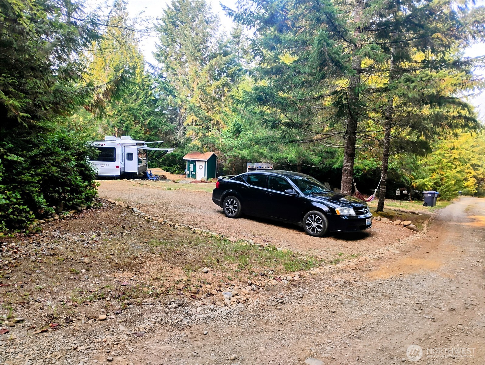 680 North Triton Heights Road Lilliwaup, WA 98555 - Photo 28 of 39 a view of a patio with table and chairs and potted plants