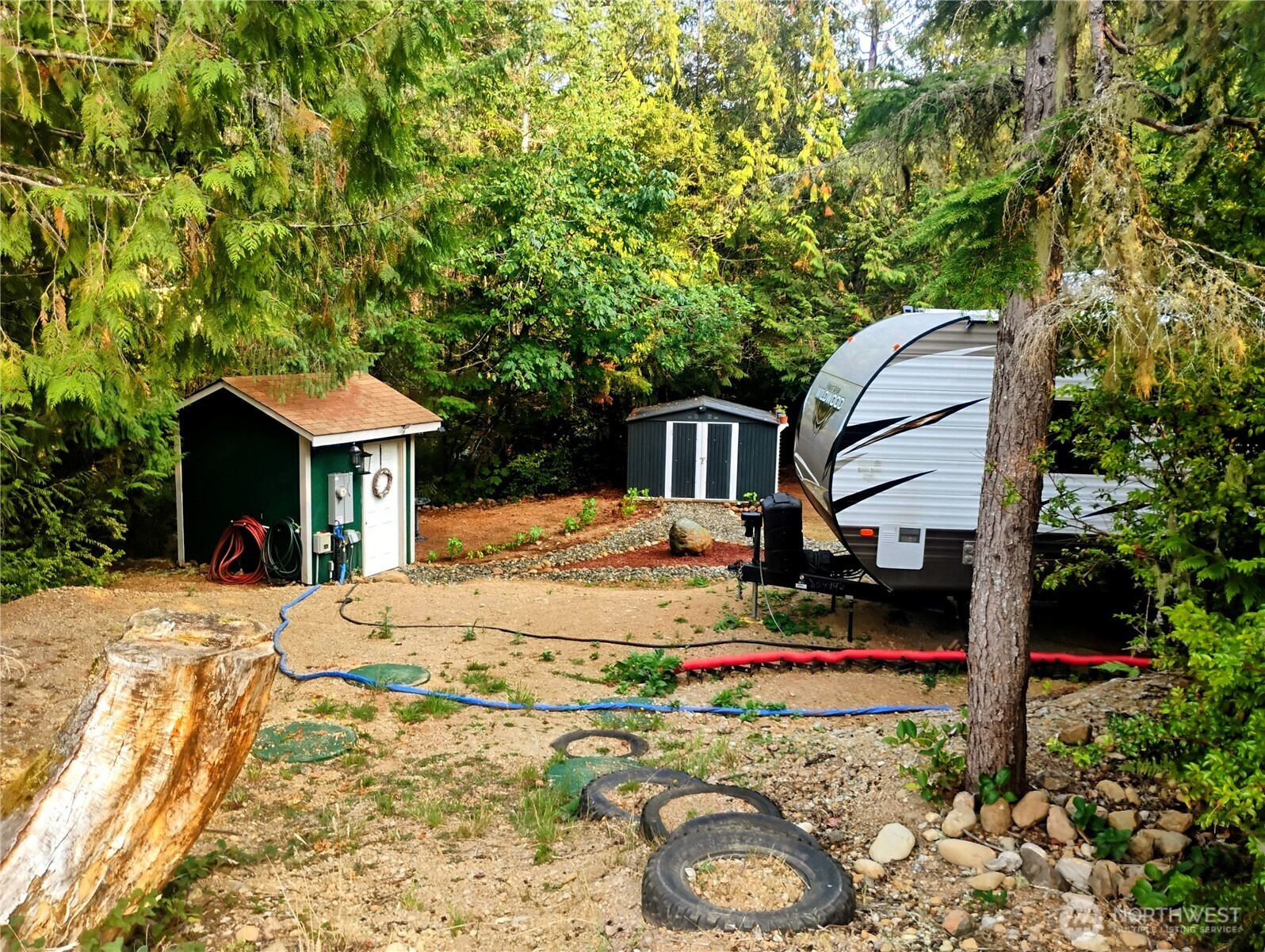 680 North Triton Heights Road Lilliwaup, WA 98555 - Photo 30 of 39 a front view of a house with garden