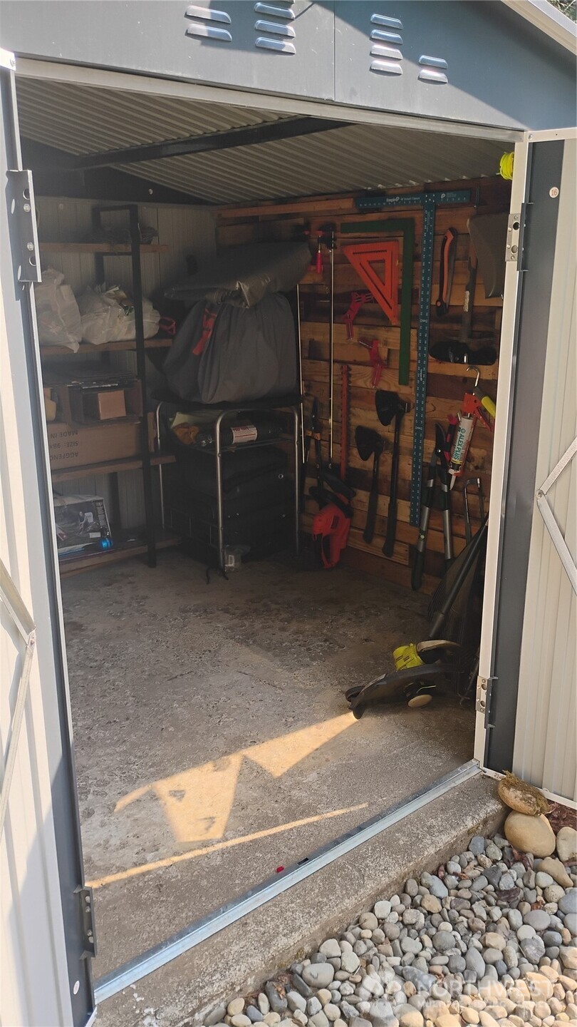 680 North Triton Heights Road Lilliwaup, WA 98555 - Photo 37 of 39 a view of room with a wooden floor and a window