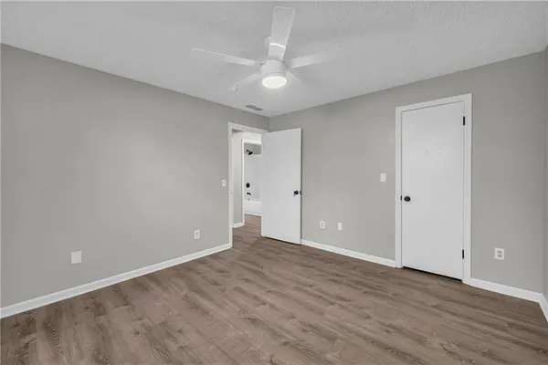 a view of an empty room with wooden floor