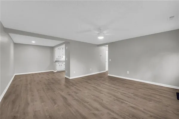 a view of an empty room with wooden floor