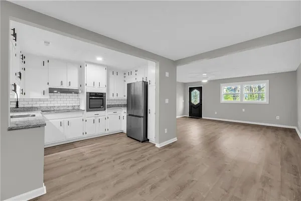 a kitchen with stainless steel appliances a refrigerator sink and cabinets