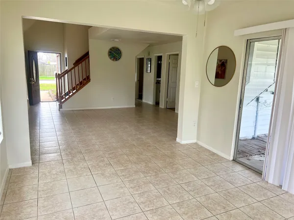 a view of a hallway to rooms and stairs