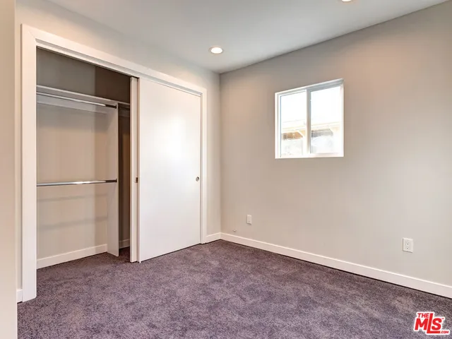 a view of an empty room with a kitchen