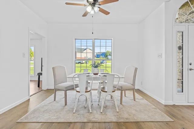 a dining room with furniture a rug and a chandelier
