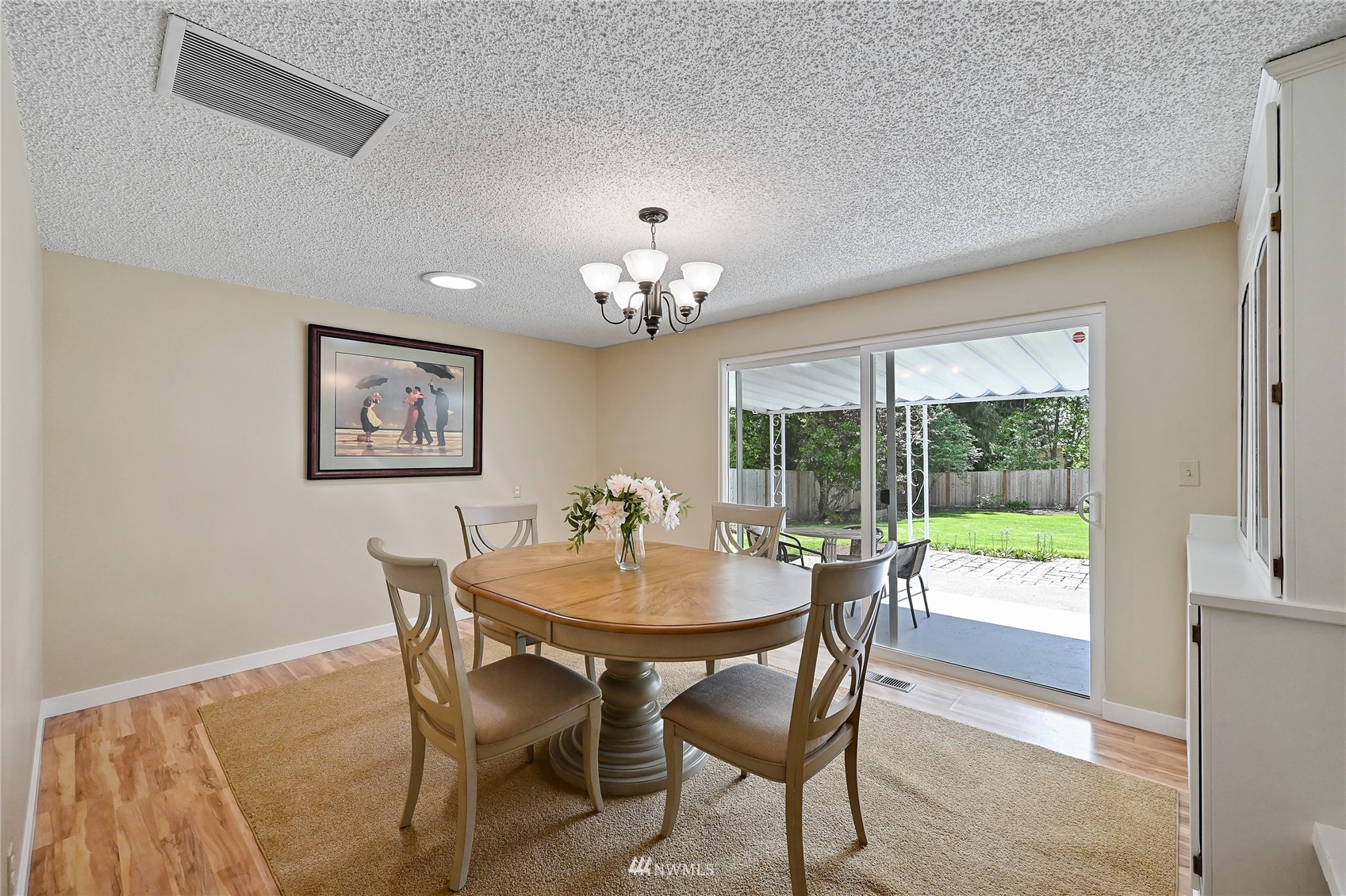 17341 Southeast 134th Street Renton, WA 98059 - Photo 12 of 36 a view of a dining room with furniture a chandelier and wooden floor