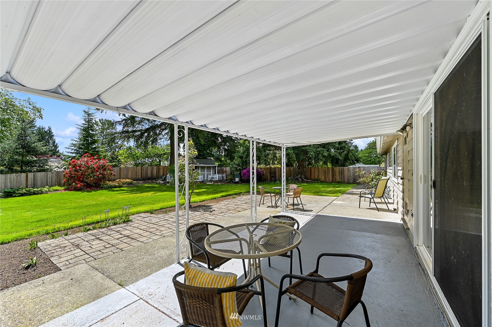 17341 Southeast 134th Street Renton, WA 98059 - Photo 21 of 36 a view of a patio with table and chairs garden and plants