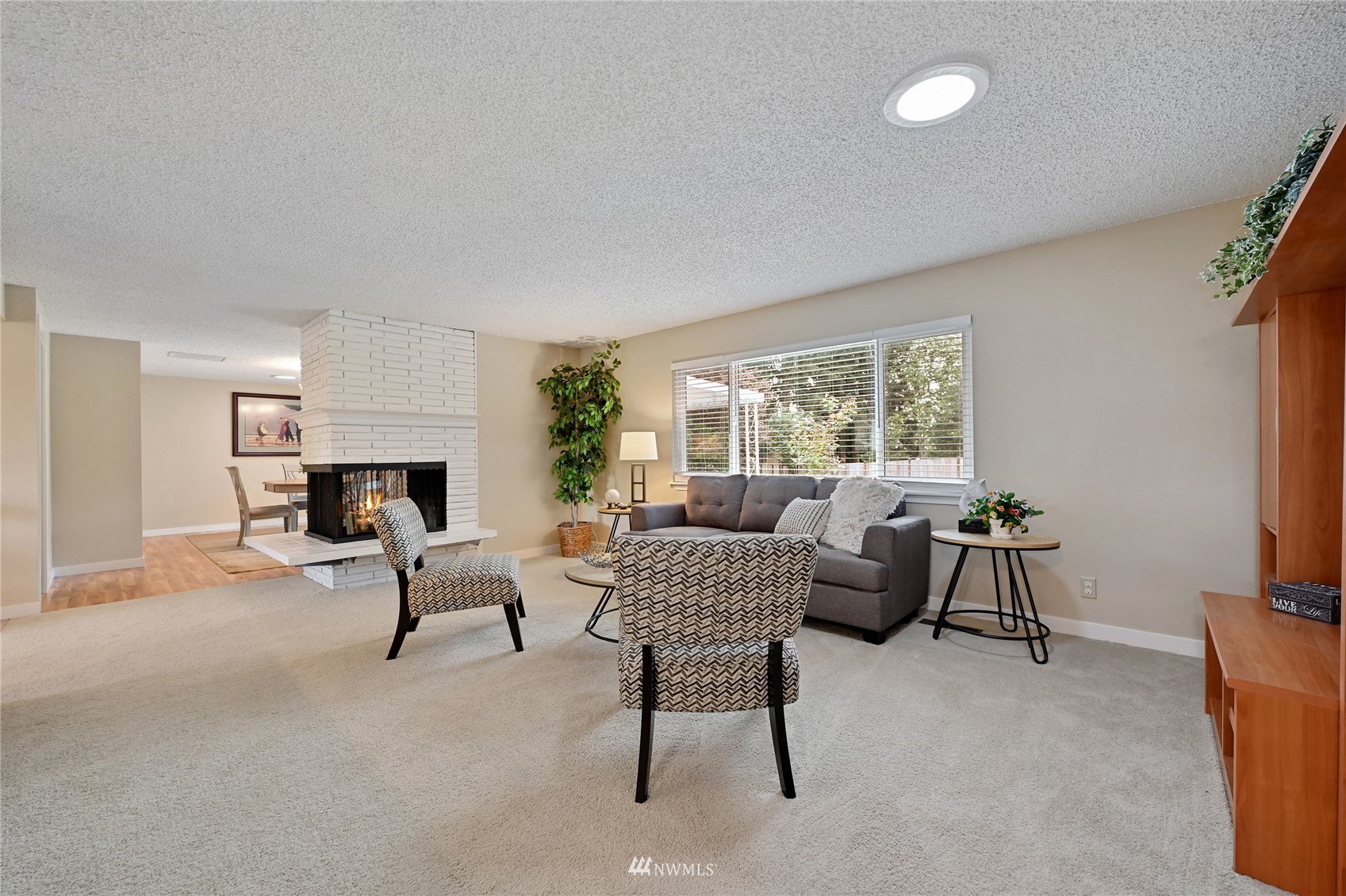 17341 Southeast 134th Street Renton, WA 98059 - Photo 5 of 36 a living room with furniture a fireplace and a flat screen tv