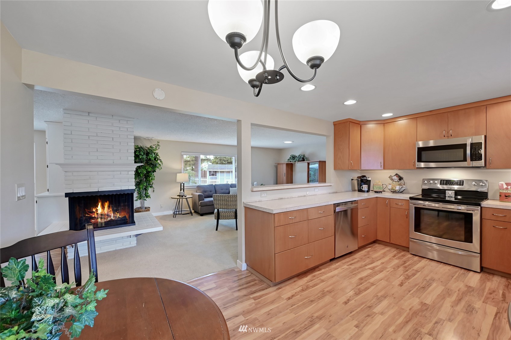 17341 Southeast 134th Street Renton, WA 98059 - Photo 10 of 36 a kitchen with microwave a stove and a wooden floors